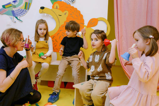 Photo by - Ksenia Chernaya  - Children-with-her-students-holding-different-color-bells