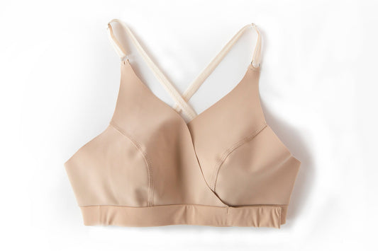 Nude one piece racerback wrap bra with magnetic and velcro closures.