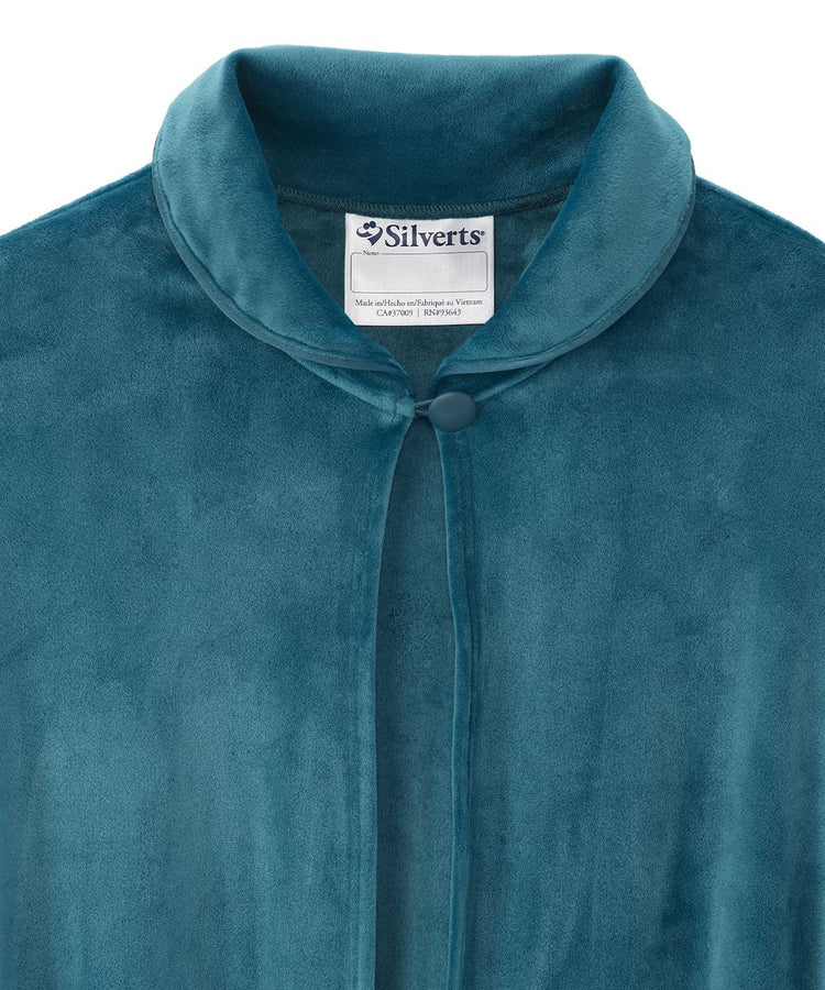 Close-up view of the Navy sleep cape's collar, displaying the Silverts brand label and the secure button closure for easy dressing