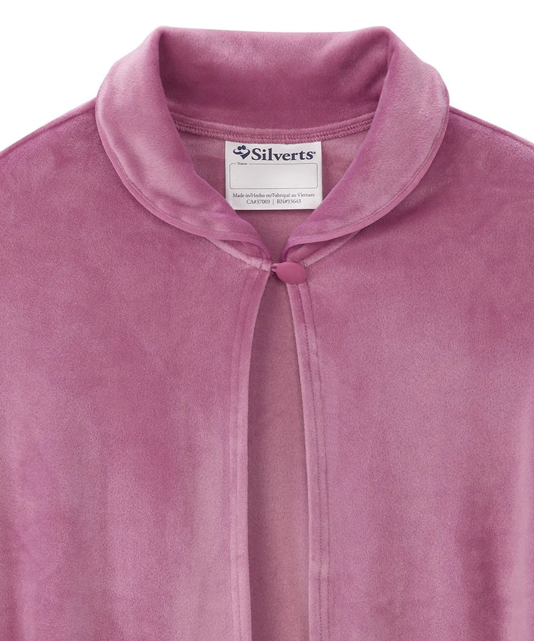 Close-up view of the Pink sleep cape's collar, displaying the Silverts brand label and the secure button closure for easy dressing