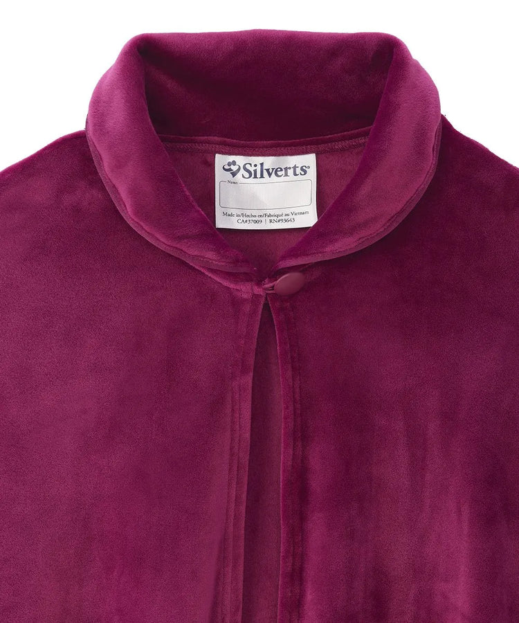 Close-up view of the Wine sleep cape's collar, displaying the Silverts brand label and the secure button closure for easy dressing