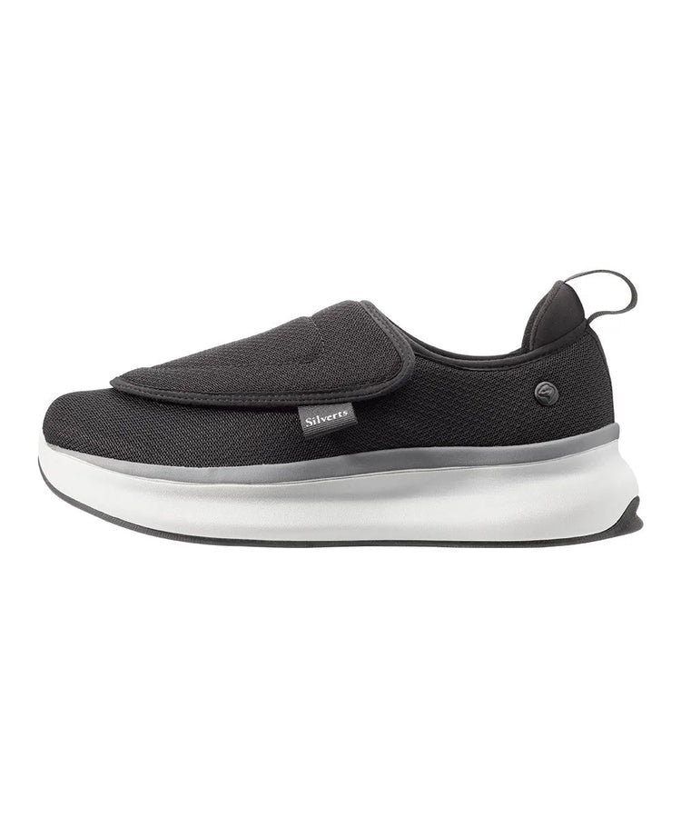 Side view of men's extra-wide adaptive footwear featuring easy-touch closures and a sleek black and gray mesh upper for superior ventilation
