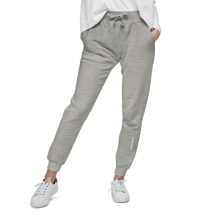 Close up of Grey sweat pant featuring " Inner peace' printed on left lower leg. 