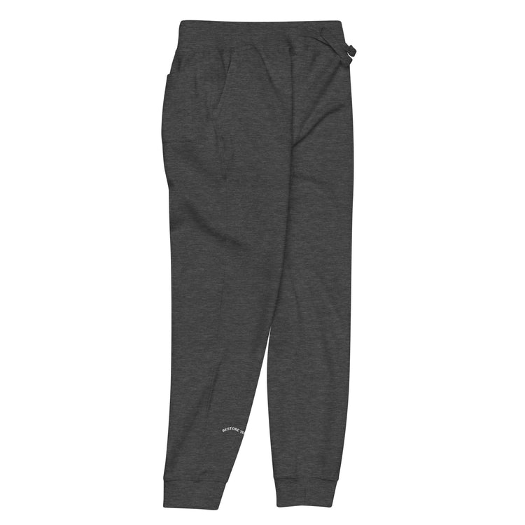 Side of full length Charcoal sweat pant with pockets on side and back, featuring "restore yourself" printed on right side lower leg.
