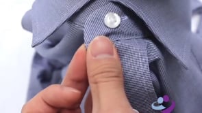 Close up of women’s blue collared shirt with easy access hidden magnetic buttons.