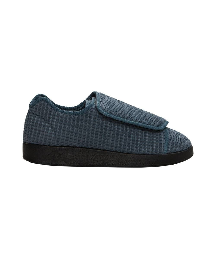 Side of wide grey indoor slippers with large Velcro closures at top for adjustable fit