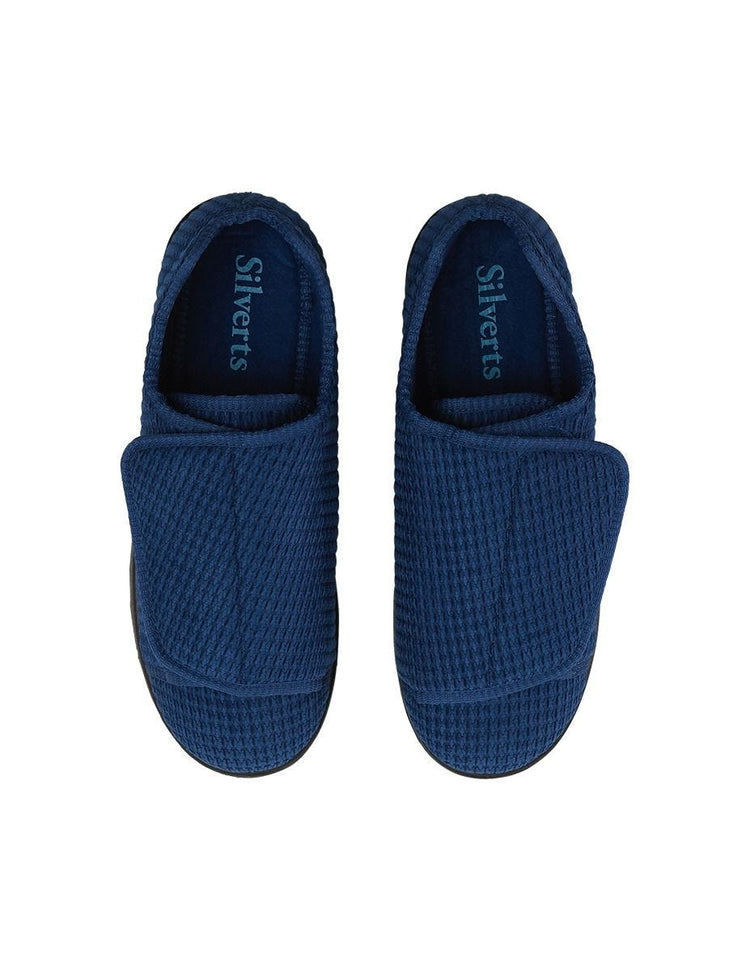 Top of extra wide navy indoor slippers feature huge velcro closures to open slipper completely