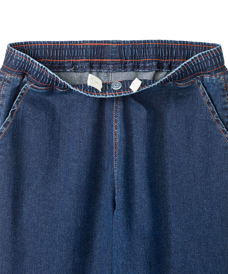 Close up of women’s indigo blue cargo jeans with pull up loops and elastic waistband.