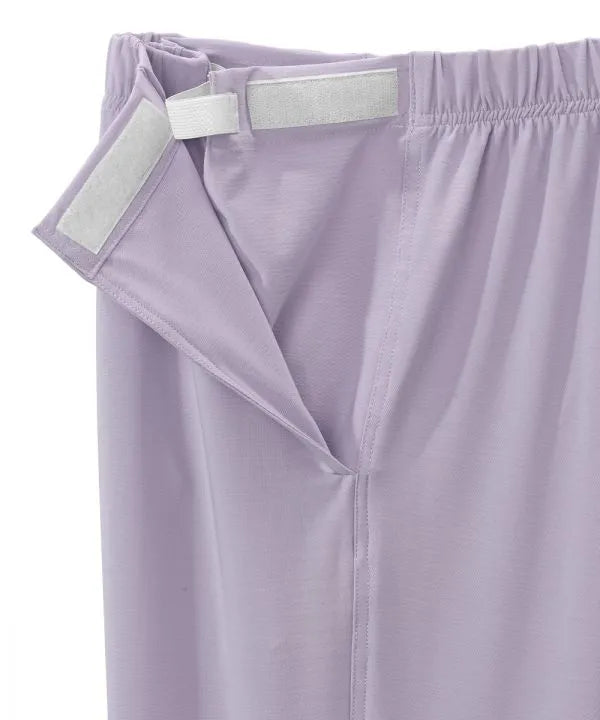 Women’s Lilac pants with side closure, adjustable straps, and loop fasteners on waistband. close-up of side closure