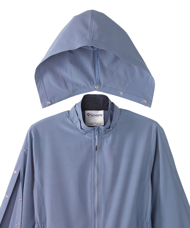 Women’s light blue rain jacket with magnetic zipper, snaps along the sleeves, and removable hood.
