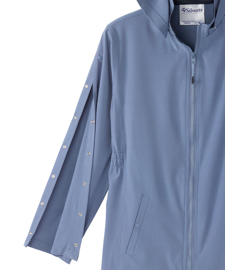 Women’s light blue rain jacket with magnetic zipper, snaps along the sleeves, and removable hood.