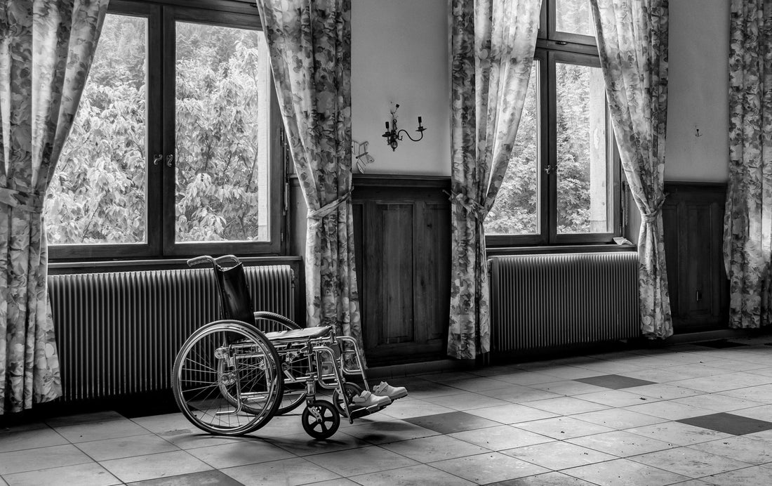 Black and white photo of a room with a wheel chair