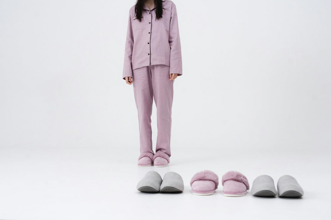 Women in her pyjamas alongside 3 pairs of comfortable sleeping shoes
