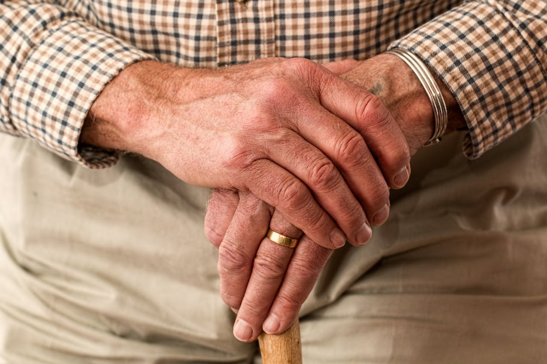 Old person's hands crossed in front of them