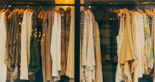 muted coloured clothing hanging on a rack