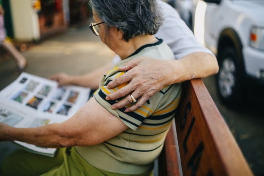 Elderly Woman reading on bench