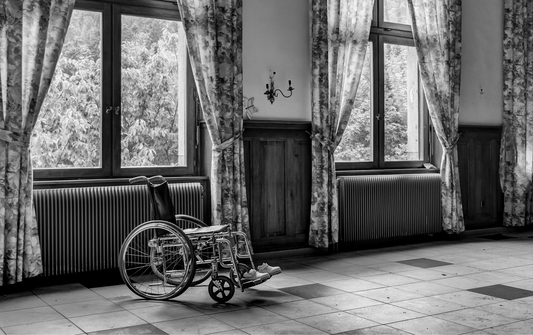 Black and White room with wheel chair in the middle