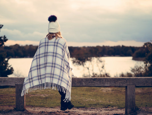 Woman sitting on bench in the cold