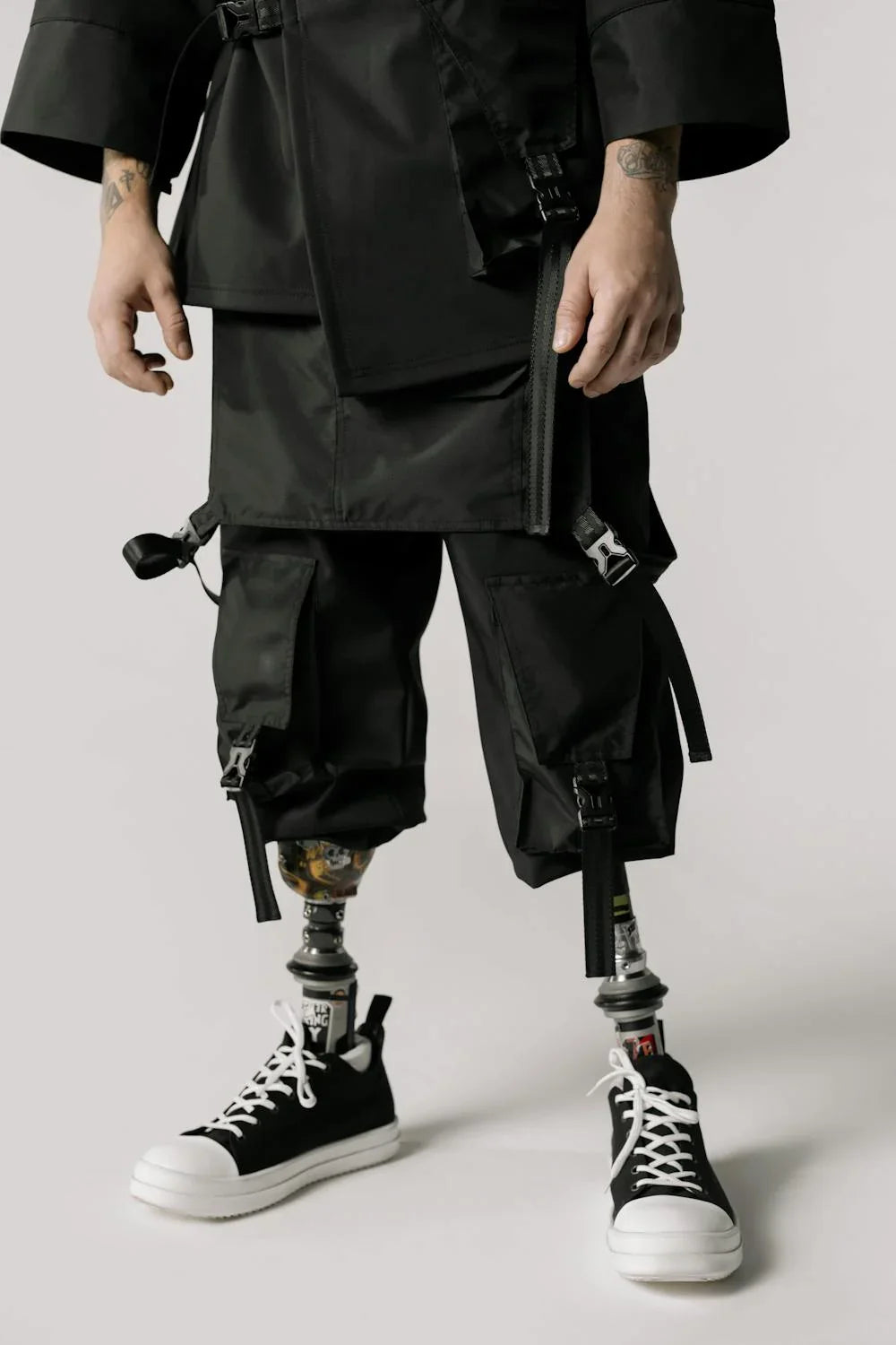 person with leg disability dressed in black wearing shoes