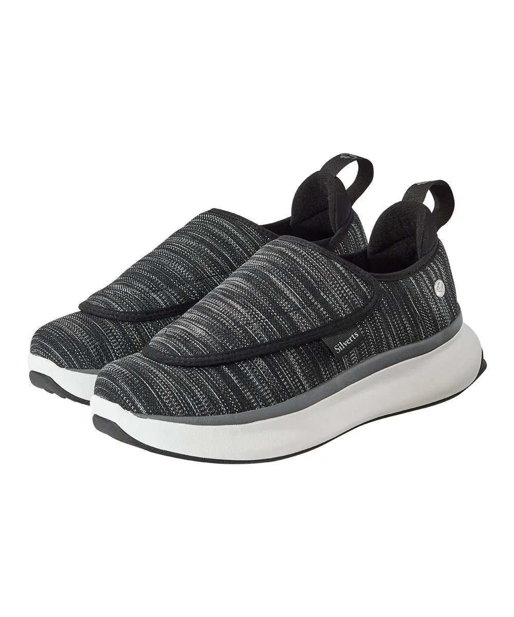 Men's extra-wide adaptive shoes worn by a model, showcasing the ease of use and supportive design with easy-touch closures, ideal for individuals with mobility issues.