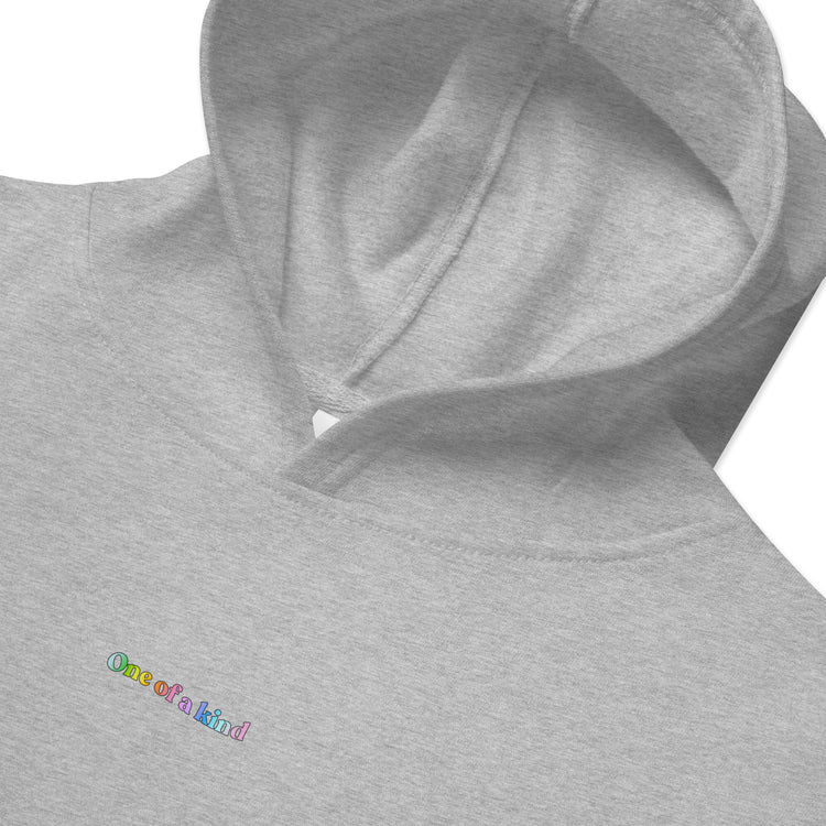 Closeup of grey Kidswear Hoodie featuring "One of a kind" printed on front.