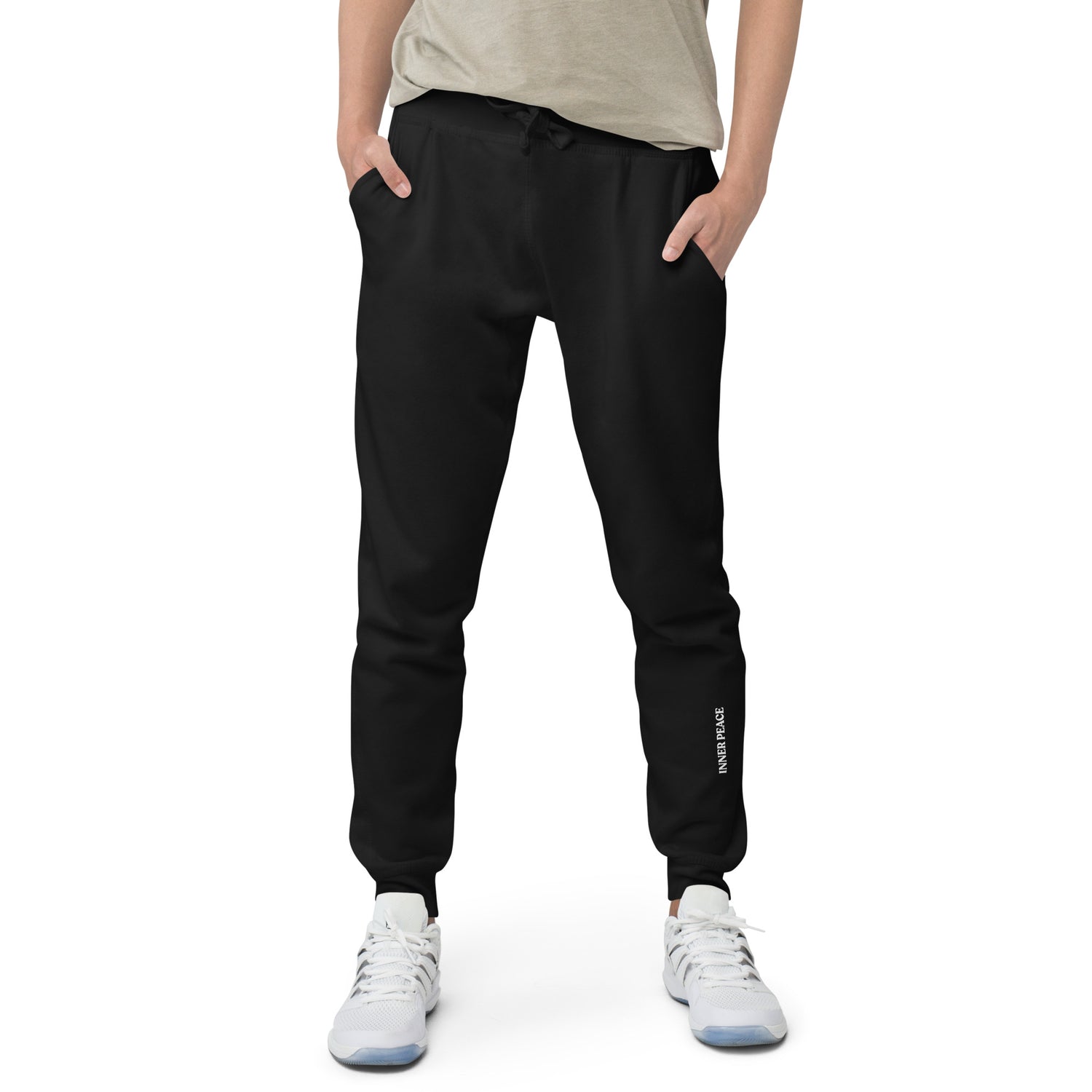 Close up of black sweat pant featuring " Inner peace' printed on left lower leg.