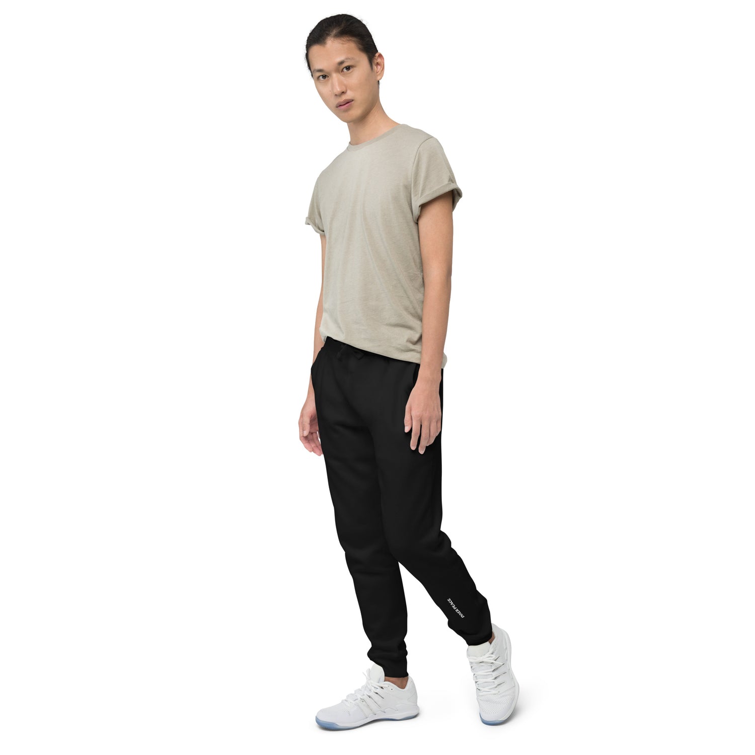Side of black sweat pant featuring " Inner peace' printed on left lower leg.