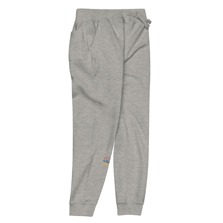 Front- right of full length grey sweat pant with pockets on side, featuring "Good vibes only" printed on right lower leg.