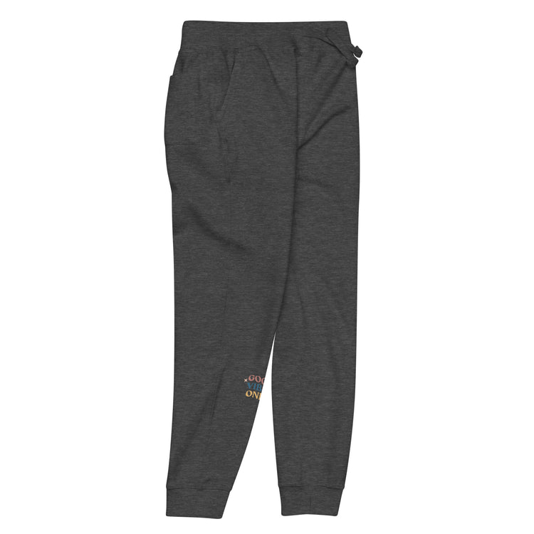 Front- right of full length charcoal sweat pant with pockets on side, featuring "Good vibes only" printed on right lower leg.