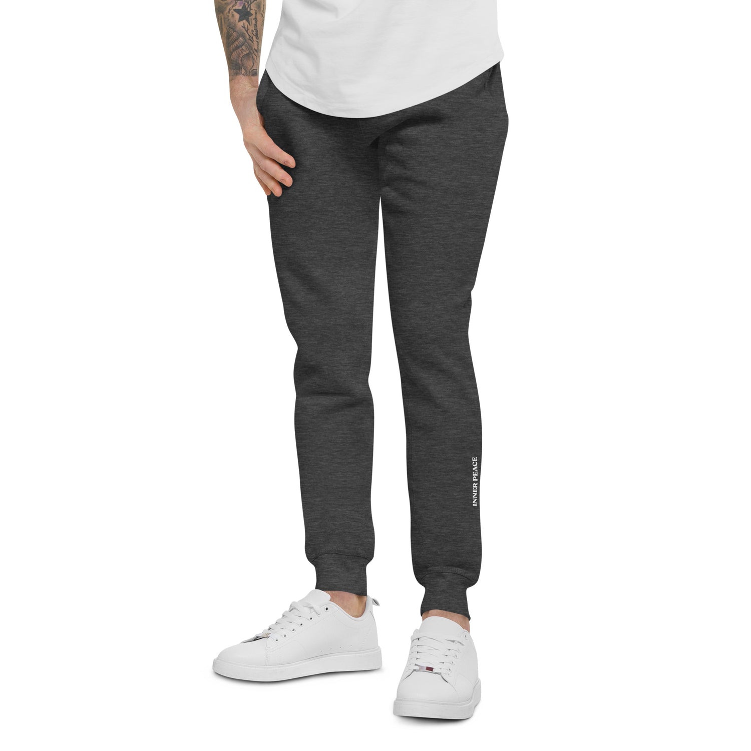 Close up of Charcoal sweat pant featuring " Inner peace' printed on left lower leg. 
