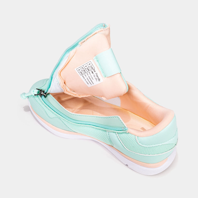 Mint women's shoe with peach accents and unzipped rear zipper access and peach interior.