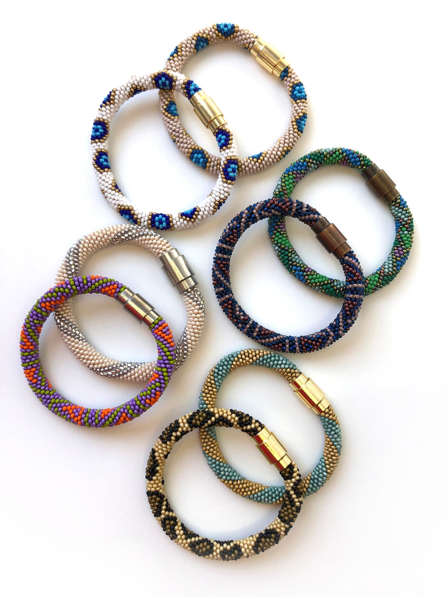 Variety of different colored bracelets with magnetic closures.