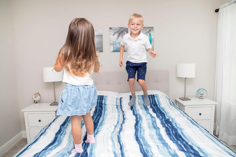 Children playing wearing anti slip socks with tread pattern on the bottom.