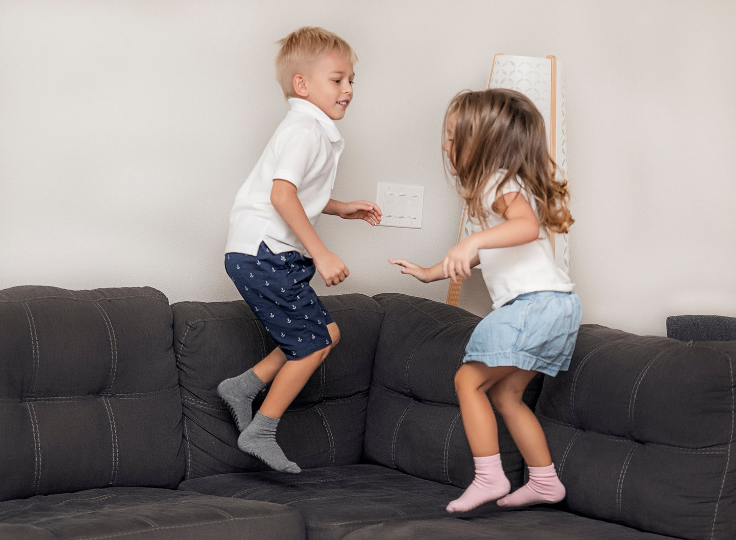 Children playing wearing anti slip socks with tread pattern on the bottom.
