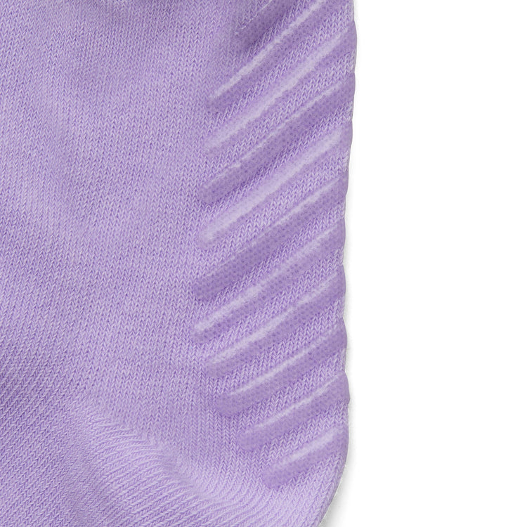 Close up of light purple anti slip kids socks with tread pattern on the bottom.