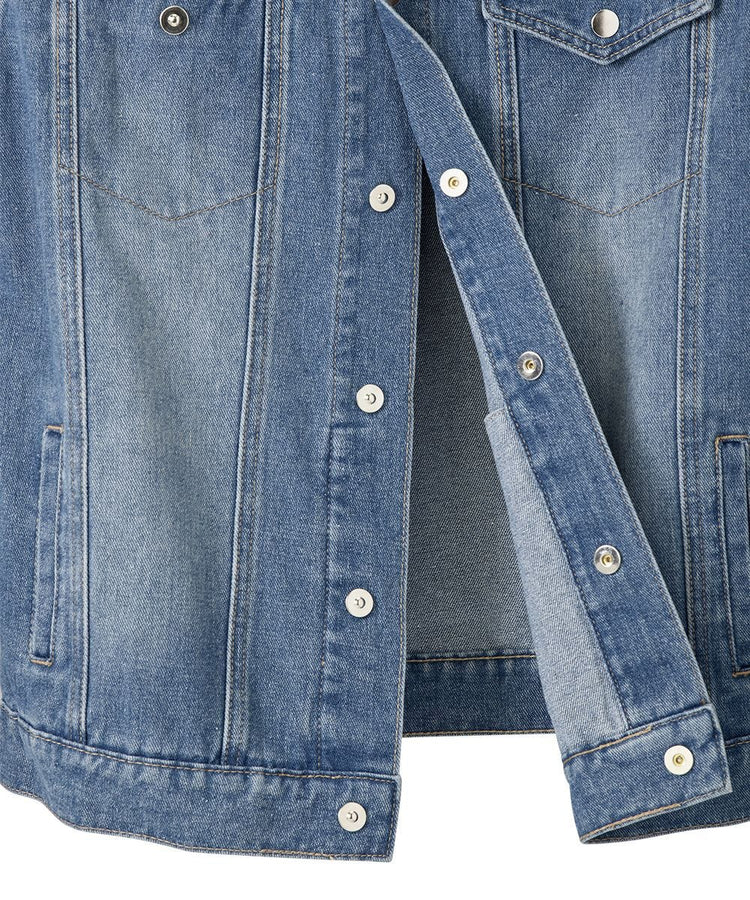 Close up of blue denim jacket with magnetic silver buttons going down the front