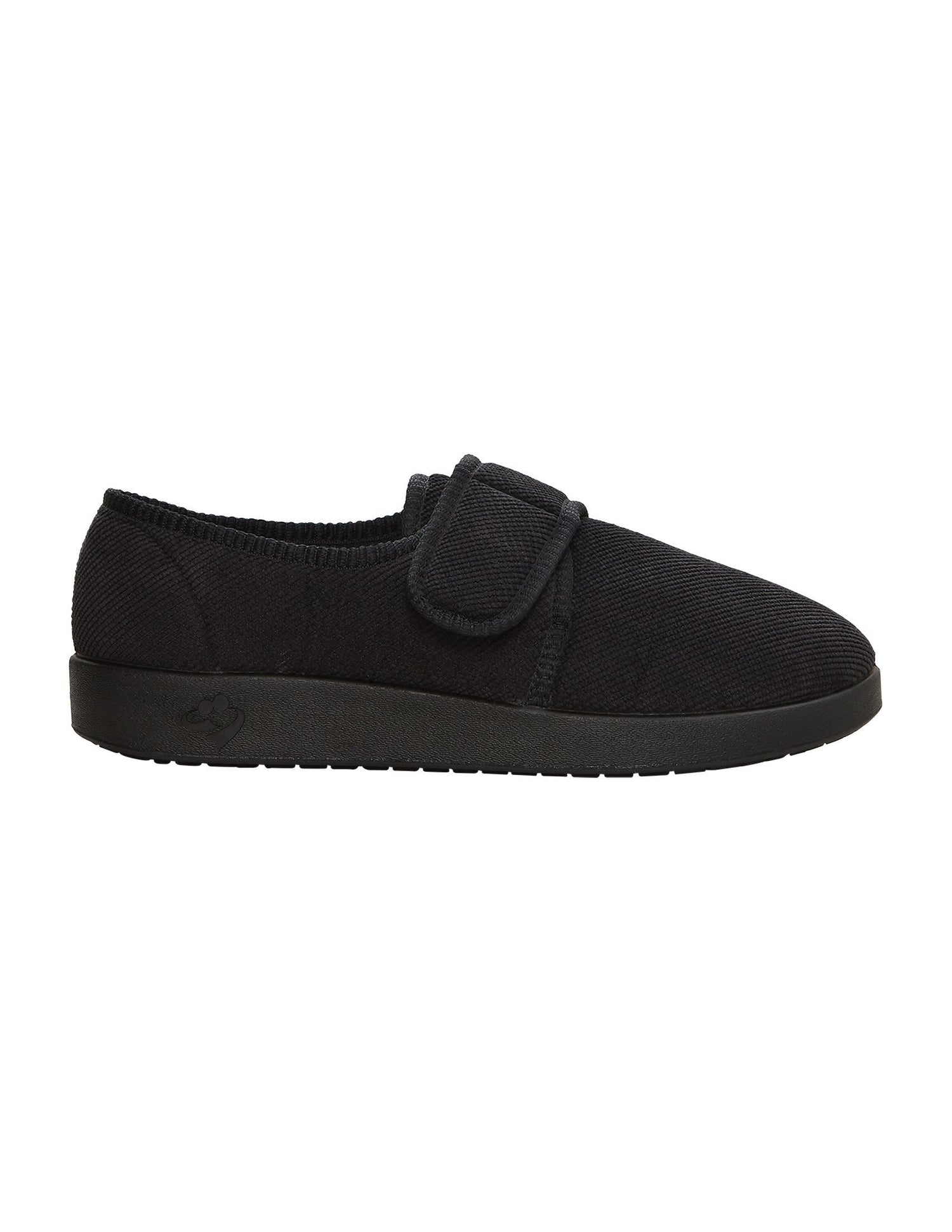 Side of wide black non-slip indoor slippers with large Velcro closure at top adjusting fit