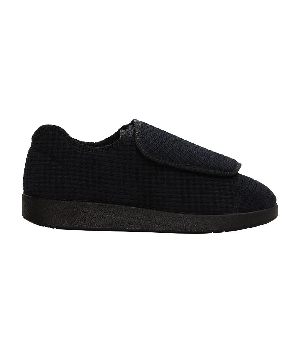 Side of wide black indoor slippers with large Velcro closures at top for adjustable fit
