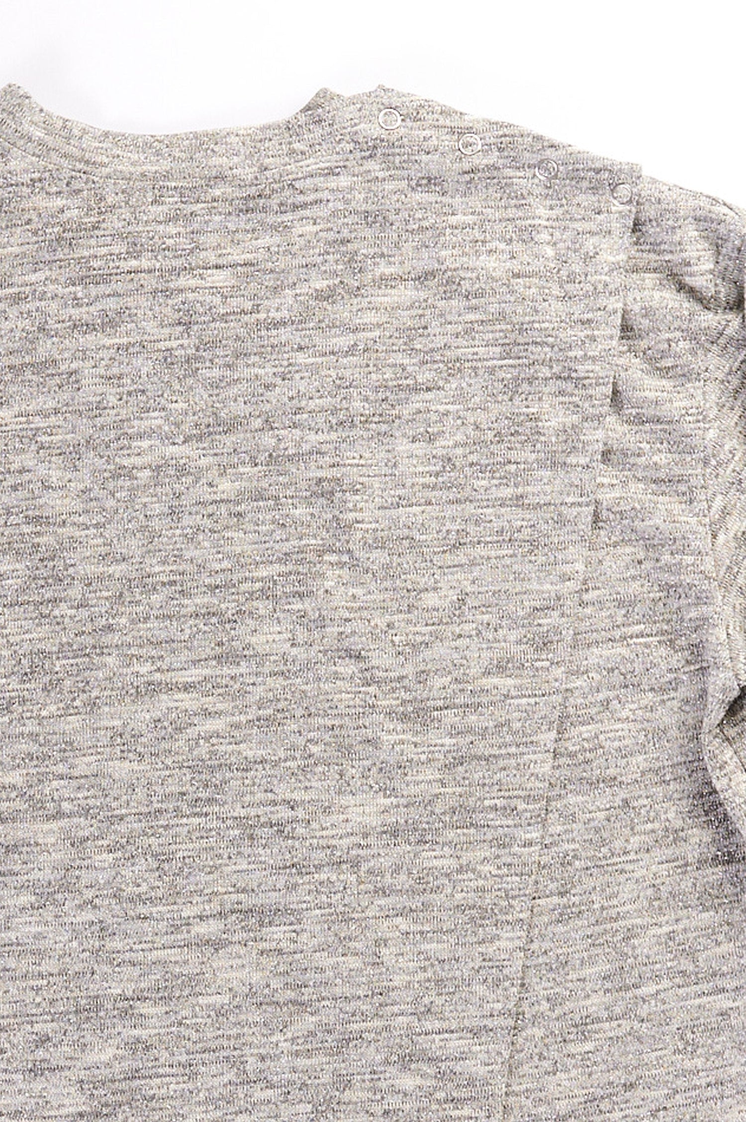 Close up of grey long sleeve top with back overlap and shoulder snap closures.