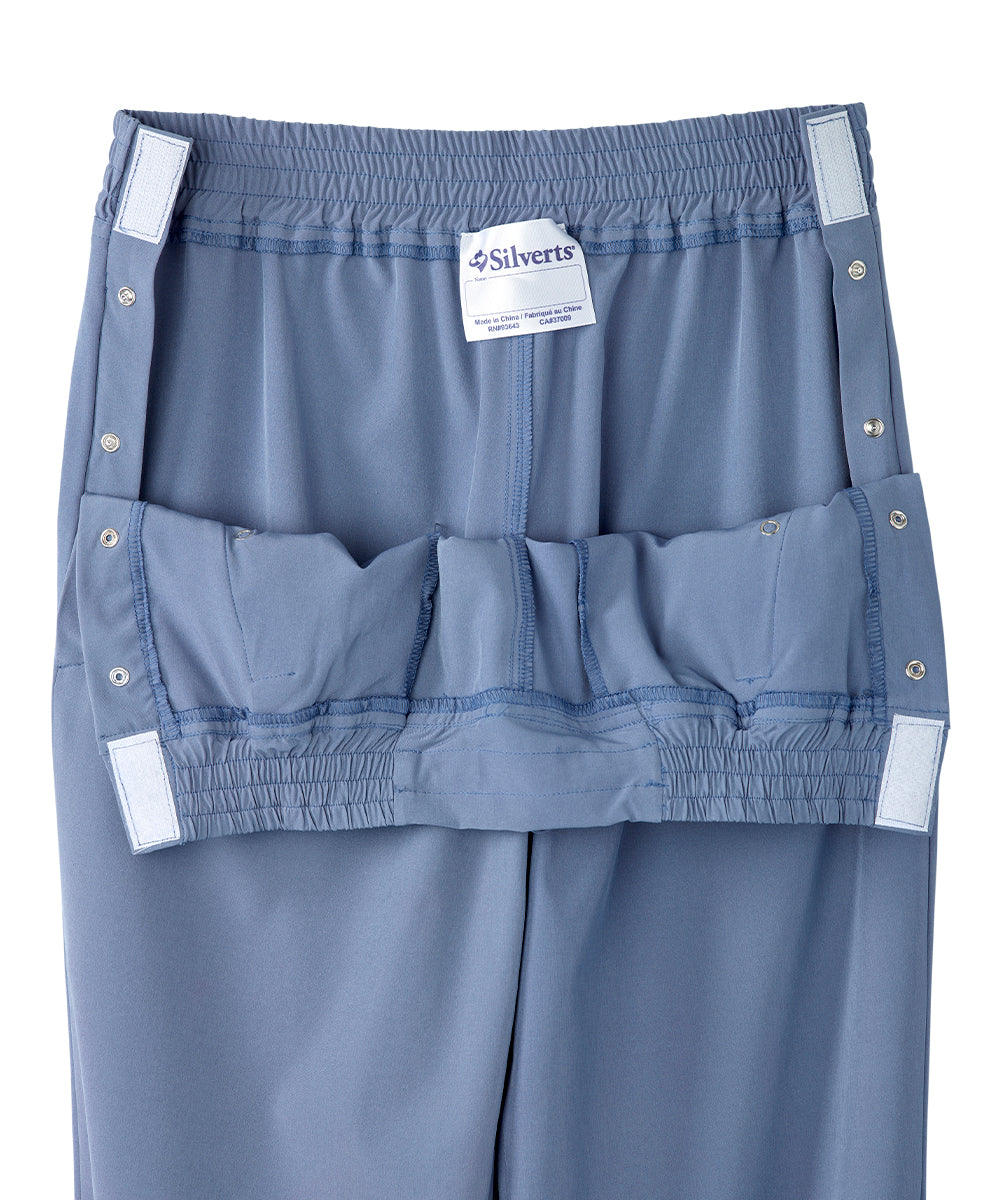 Close up of waist of women’s light blue leisure pants with snaps and elastic waistband.