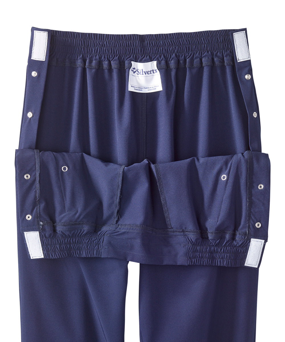 Close up of waist of women’s navy blue leisure pants with snaps and elastic waistband.