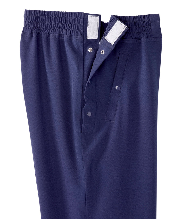 Close up of waist of women’s navy blue leisure pants with snaps and elastic waistband.