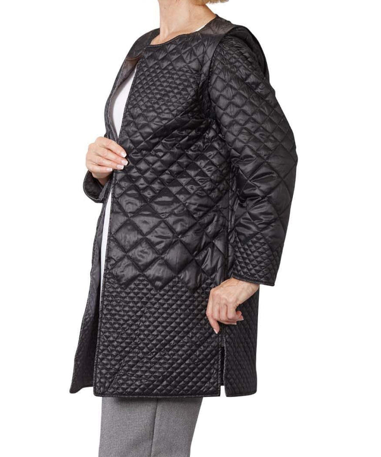 Women’s black quilted reversible jacket with side seam pockets and removable sleeves.