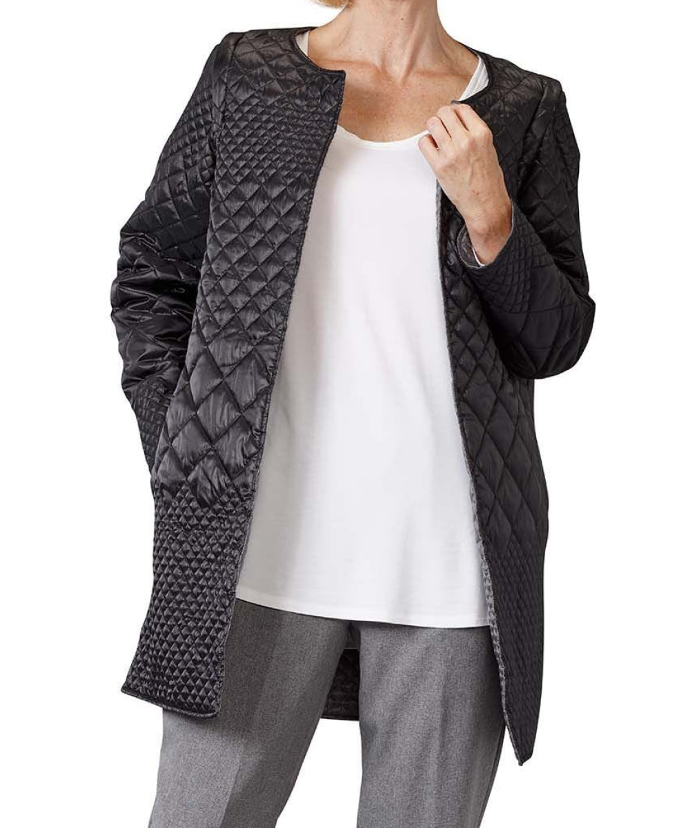 Women’s black quilted reversible jacket with side seam pockets and removable sleeves.