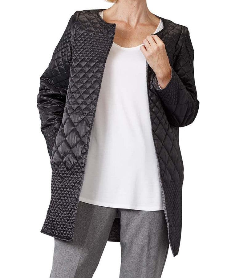 Women’s black quilted reversible jacket with side seam pockets and removable sleeves.