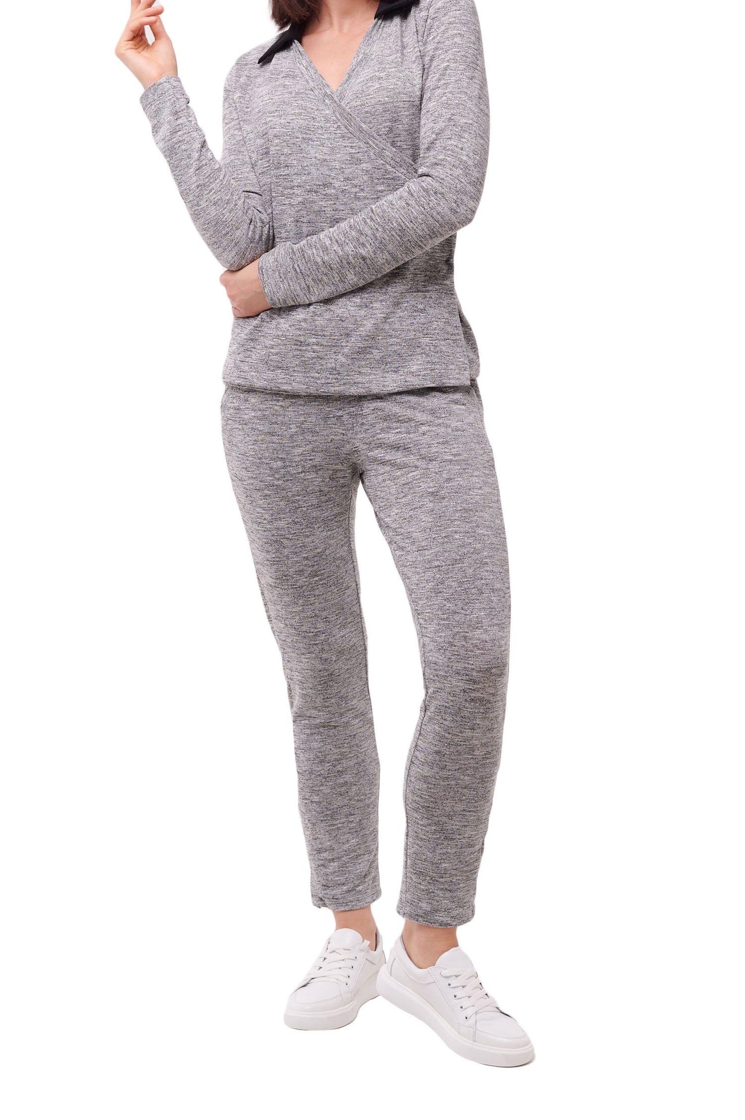 Woman wearing grey full length slim comfort pants with ankle snap closures and matching top.