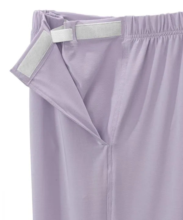 Women’s Lilac pants with side closure, adjustable straps, and loop fasteners on waistband.  close-up of side closure