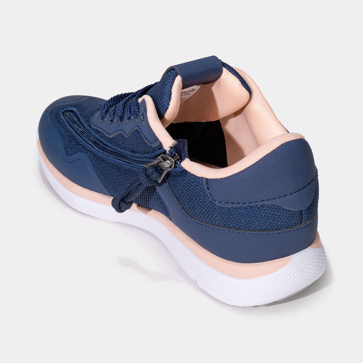 Navy blue women's shoe with white bottom, peach accents, and rear zipper access.