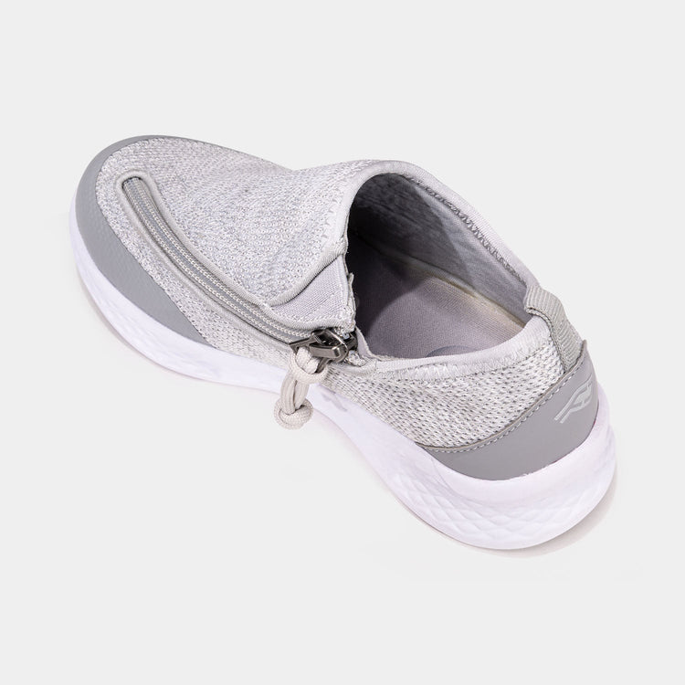 Grey kids shoe with white bottom, dark grey accents, and side zipper access.