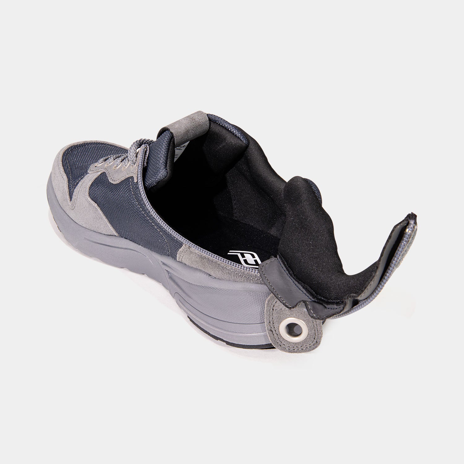 Medium grey mens shoe with unzipped rear zipper access and black interior.